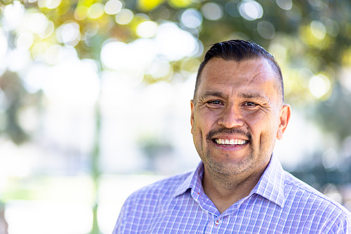 Portrait of a Handsome Mexican man at the park